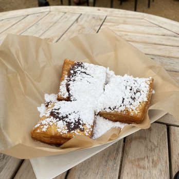 Meaux Beignet - a plate of food on a table - Food Trucks Near Me - Bentonville, Arkansas Meaux Beignet - a plate of food on a table - Food Trucks Near Me - Bentonville, Arkansas