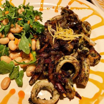 Bella Monica - Sautéed Calamari with white bean arugula salad. - Italian Near Me - Raleigh, North Carolina Bella Monica - Sautéed Calamari with white bean arugula salad. - Italian Near Me - Raleigh, North Carolina