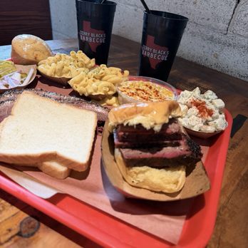 Terry Black's Barbecue - Brisket sandwich, slices of bbq brisket, mac and cheese, potato salad, cornbread, cream of corn. - Barbeque Near Me - Dallas, Texas