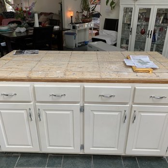 JP General Construction - a kitchen island in the middle of a living room - General Contractors Near Me
