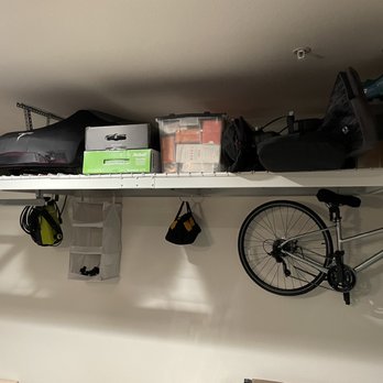 The Clever Home - garage rack storage overhead and off to the side - Home Organization Near Me