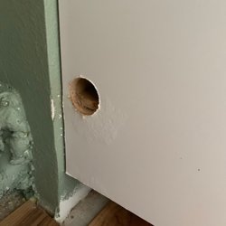 Cutter Construction - Water damage to cabinets due to a hose that was left disconnected from laundry sink behind washer/dryer