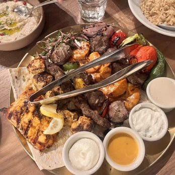 Ammatoli - Family Mashwahi Feast with each of the skewers. The ribeye was a favorite! Loved all of the sauces that accompany the meal! - Mediterranean Near Me - Long Beach, California