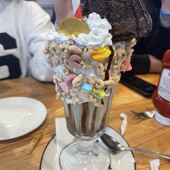 EC Diner - St Pats day - Rim coated marshmallows & lucky charms. Mint chocolate chip topped with whipped cream & garnished with a chocolate brownie. - American Near Me - Ellicott City, Maryland EC Diner - St Pats day - Rim coated marshmallows & lucky charms. Mint chocolate chip topped with whipped cream & garnished with a chocolate brownie. - American Near Me - Ellicott City, Maryland