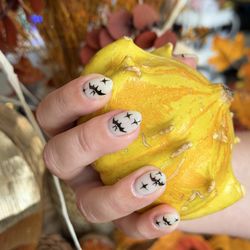 Golden File Nail Spa - Cute ghosts park on her nails