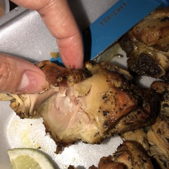 La Casa De Los Chimis - a person picking up a piece of chicken - Imported Food Near Me - Orlando, Florida La Casa De Los Chimis - a person picking up a piece of chicken - Imported Food Near Me - Orlando, Florida