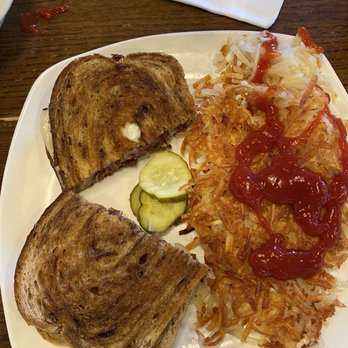 Eggbert's - Classic Reuben Sandwich without sauerkraut in photo and side of hash browns with customer added ketchup. - Breakfast & Brunch Near Me - Bartlesville, Oklahoma
