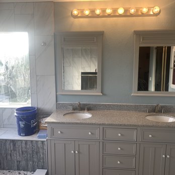 Iron Hands construction  - After: vanity, mirrors, light fixture, bench and medicine cabinet. - General Contractors Near Me