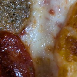 I've been ordering the same thing for ten years. Yesterday I picked up my pizza and got home to find. A BIG BLACK HAIR SPRAWLED ACROSS .