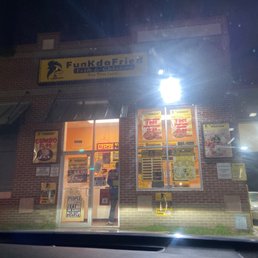 Exterior outside entrance of Funk Da Fried Fish & Chicken - Front of the restaurant in the evening time - Dallas, Texas Exterior outside entrance of Funk Da Fried Fish & Chicken - Front of the restaurant in the evening time - Dallas, Texas