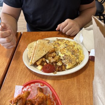 Purple Sage Cafe - a man sitting at a table with a plate of food - Cafes Near Me - Dunnellon, Florida Purple Sage Cafe - a man sitting at a table with a plate of food - Cafes Near Me - Dunnellon, Florida