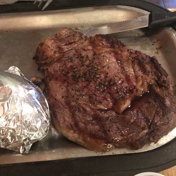 Geno's Steakhouse - a large steak on a pan - Steakhouses Near Me - Wayne, Nebraska