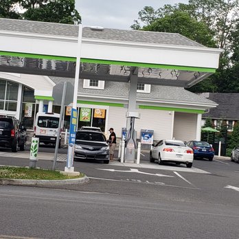 Cumberland Farms - a woman standing in front of a gas station - Convenience Stores Near Me - NAUGATUCK, Connecticut