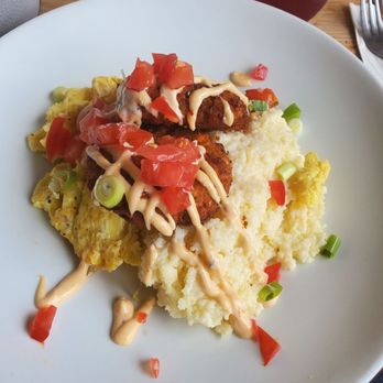 Milkweed - Salmon cakes with cheese grits and scrambled eggs topped with tomatoes - New American Near Me - Boston, Massachusetts