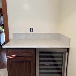 A & G Construction Solutions - Added cabinet, wine fridge, and nice quartz top.