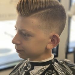 The Majestic Barbershop - Straight med-coarse hair combs nicely to the side with some length. Mid-high taper with a hard line part added to finish this look.