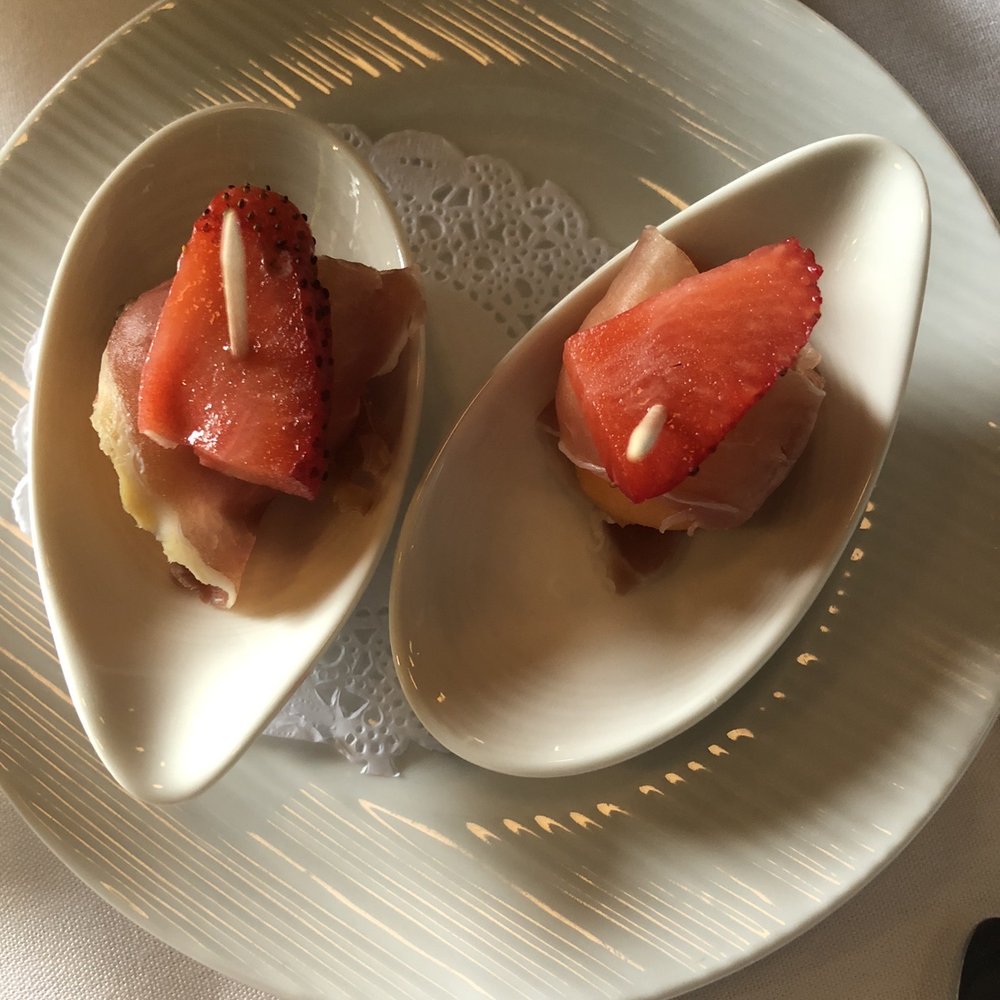 Marco's Kitchen - Complementary starter - melon wrapped in prosciutto with strawberry - French Near Me - La Grange, Illinois