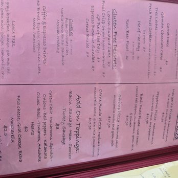 Tune-Up Cafe - Menu May 2025 - The menu page is pink with handwritten-style text, listing dessert options including gluten-free pistachios, coffee espresso, and coconut. It also features takeout options like grilled chicken, cheese, and various pizza dishes. The menu includes prices and descriptions of each item, indicating a focus on desserts and takeout food offerings at a cafe or restaurant. - New Mexican Cuisine Near Me - Santa Fe, New Mexico