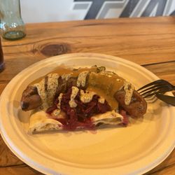 Pork brat with red cabbage pickles and restaurants in house bread.