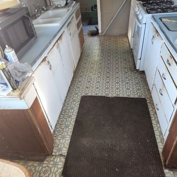 Indoor Victory - My galley kitchen with vinyl flooring and outdated cabinets to include countertop and sink. - General Contractors Near Me - Wichita , Kansas