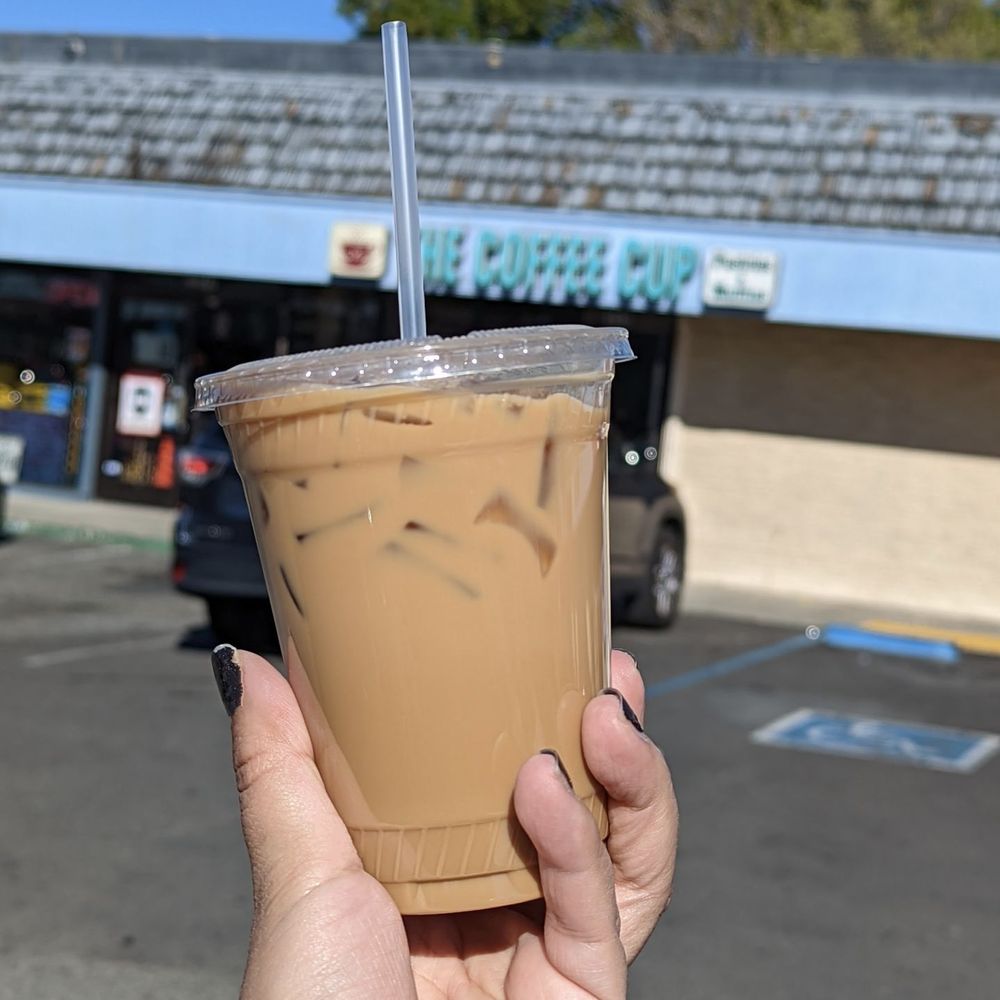 The Coffee Cup - a hand holding a cup of iced coffee - Coffee & Tea Near Me - San Jose, California The Coffee Cup - a hand holding a cup of iced coffee - Coffee & Tea Near Me - San Jose, California