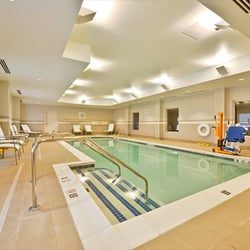 Holiday Inn Express & Suites Utica - Indoor pool opens directly to the patio in back of the hotel overlooking the Mohawk River