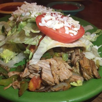 Los Jimadores - The pork burrito with sautéed onions & peppers then topped with guacamole, sour cream, lettuce, tomato & cheese rocks. - Mexican Near Me - Macon, Missouri