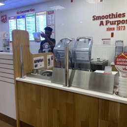 a counter with smoothies with a purpose sign