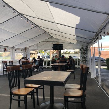 Parrilla's Cholito - tables and chairs under a tent - Peruvian Near Me - Downey, California