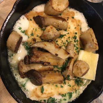 Ash'Kara - Saganaki. It came to the ... counter (I ate at the hummus bar.) sizzling. Those are mushrooms on top, too. Mmm .... Warm and filling. - Mediterranean Near Me - Denver, Colorado