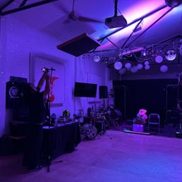 a large room with a stage set up for a concert