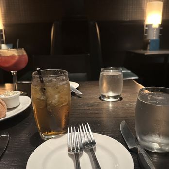 The Keg Steakhouse + Bar - a table setting with a drink and a sandwich - Steakhouses Near Me - Toronto, Ontario