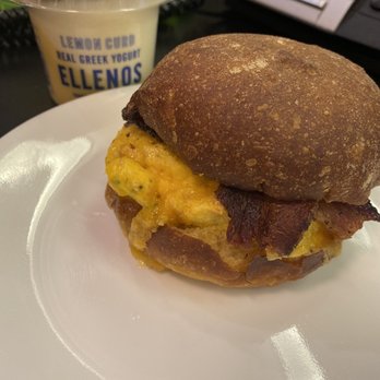 Uptown Espresso - Belltown - Egg bacon and cheese on potato bread sandwich. Mango ellenos Greek yogurt in the back - Coffee & Tea Near Me - Seattle, Washington