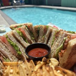 Upper Deck Hotel & Bar - Turkey club and waffle fries poolside