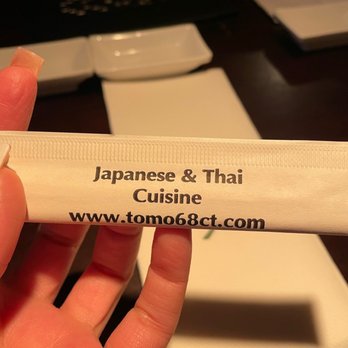Tomo 68 - a person holding a tube of toothpaste - Asian Fusion Near Me - Naugatuck, Connecticut