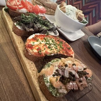 Postino Heights - BRUSCHETTA ( CHOOSE 4 ) - MOZZARELLA & TOMATOES - mushroom and mascarpone - spicy jam and goat cheese - smoked salmon and pesto - Wine Bars Near Me - Houston, Texas Postino Heights - BRUSCHETTA ( CHOOSE 4 ) - MOZZARELLA & TOMATOES - mushroom and mascarpone - spicy jam and goat cheese - smoked salmon and pesto - Wine Bars Near Me - Houston, Texas