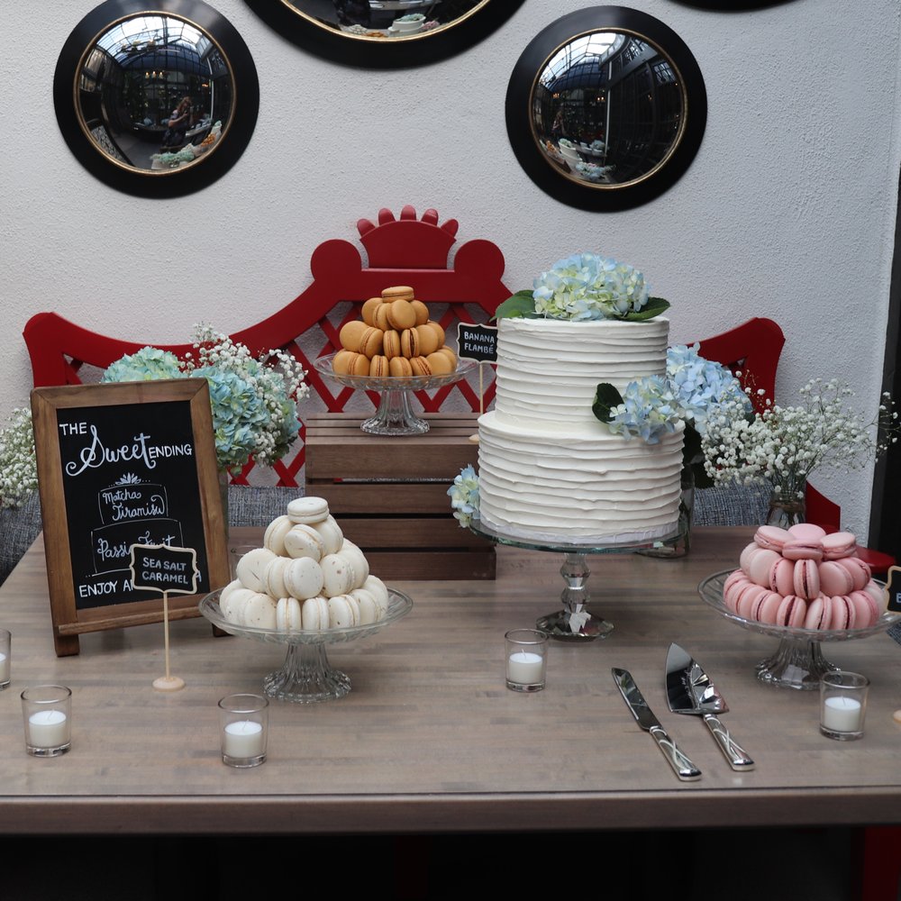 Frosted by Pibeny - Dessert table. Cake was matcha tiramisu on top, passion fruit on the bottom. Macarons were Banana flambe, mixed berry, and sea salt caramel - Patisserie/Cake Shop Near Me Frosted by Pibeny - Dessert table. Cake was matcha tiramisu on top, passion fruit on the bottom. Macarons were Banana flambe, mixed berry, and sea salt caramel - Patisserie/Cake Shop Near Me