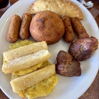 Carolinas Cuban Cafe - Sampler with yucca Yuca Frita, Tostones, Papa Rellena, croquetas, Empanadas, Masas de Cerdo Frita - Cuban Near Me - Port Richey, Florida Carolinas Cuban Cafe - Sampler with yucca Yuca Frita, Tostones, Papa Rellena, croquetas, Empanadas, Masas de Cerdo Frita - Cuban Near Me - Port Richey, Florida