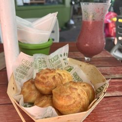 Empório Jardim - Cheese bread, one portion is three. We got two orders. In the background the berry smoothie. Both delicious!!