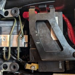 Motorcycle Mall - Notice the battery hold down directly over the positive terminal, and not connected on the top.  This is how my bike left their dealership.