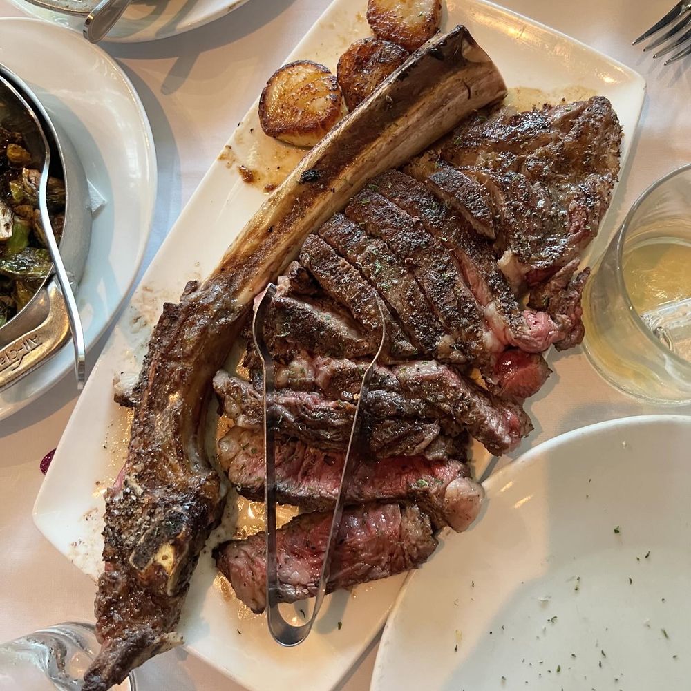 Fleming’s Prime Steakhouse & Wine Bar - Tomahawk steak with a side of seared scallops - Wine Bars Near Me - Plano, Texas Fleming’s Prime Steakhouse & Wine Bar - Tomahawk steak with a side of seared scallops - Wine Bars Near Me - Plano, Texas