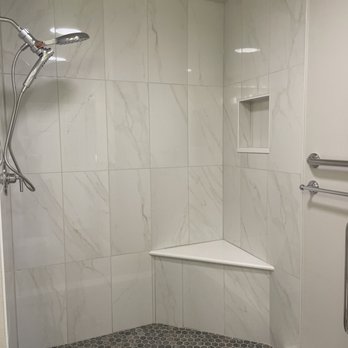Tiger Team Remodeling - a bathroom with a shower - Damage Restoration Near Me - Littleton, Colorado Tiger Team Remodeling - a bathroom with a shower - Damage Restoration Near Me - Littleton, Colorado