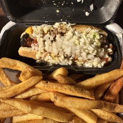 Chili slaw dog with onions, ketchup and mustard with fries.