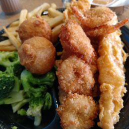 Catfish and shrimp with broccoli and fries.