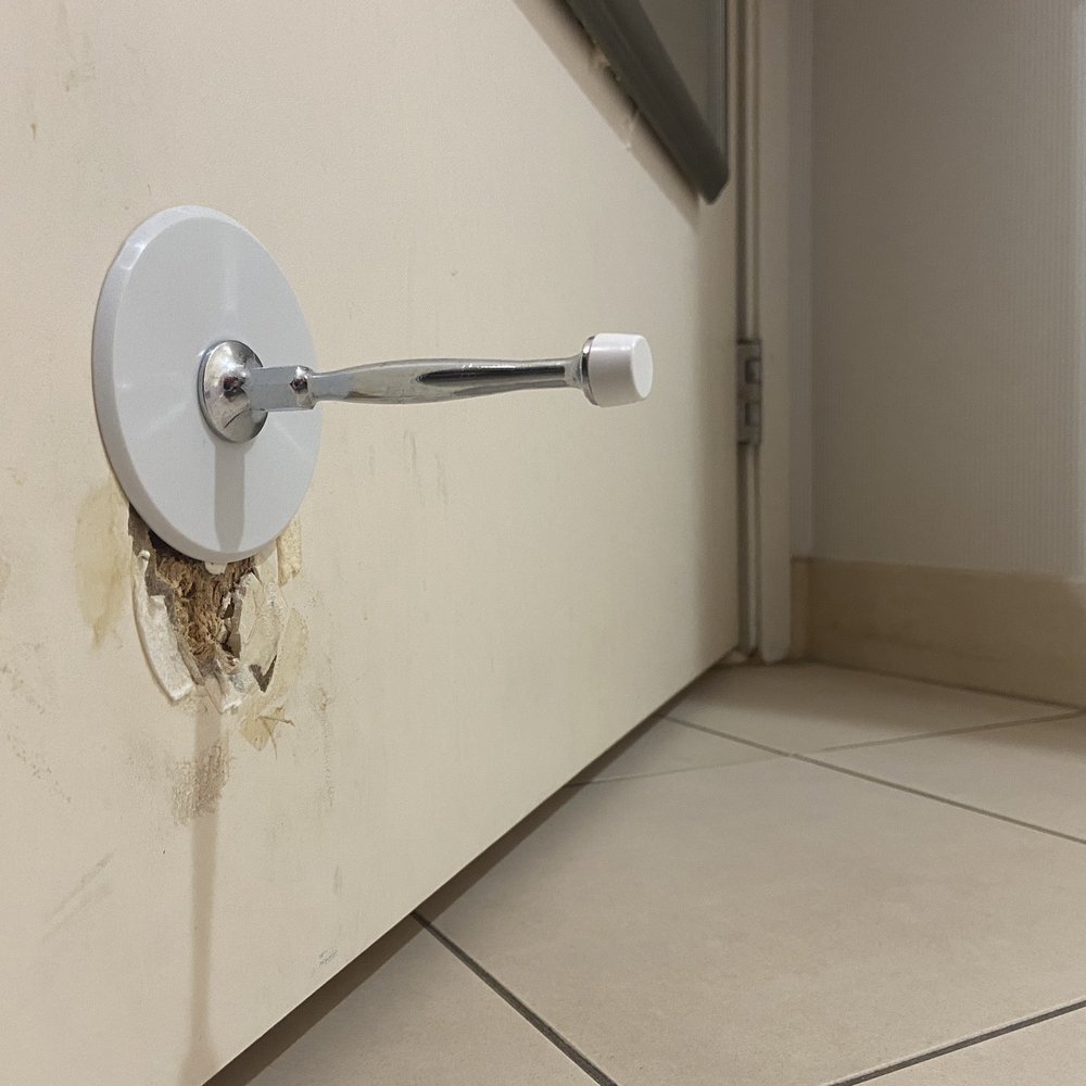 Poorly repaired door stop Poorly repaired door stop