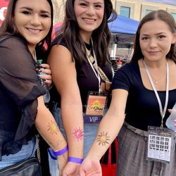 Amy's Artistic Expressions - Three lovely ladies memorializing one of their brothers, with matching glitter tattoos by Amy. 2025 CARE Fair, downtown Moses Lake, WA.