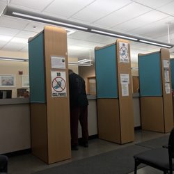 Departments of Motor Vehicles - Empty booths, full waiting room.