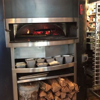 Pizzeria Toro - We sat right next to the oven. Cozy warm and right in the action. Watched the oven master working the pizzas and escarole around: very cool! - Pizza Near Me - Durham, North Carolina