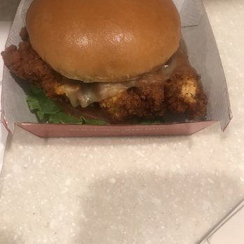 Chick-fil-A - The wrong sandwich. - A fried chicken sandwich with melted cheese in a bun, served in a cardboard box on a light-colored countertop. - Fast Food Near Me - Worcester, Massachusetts