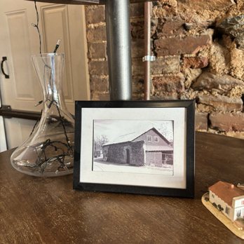 Pizza Norcia - Framed photo of the bldg in days past.That same brick wall still exists.It's the wall behind the framed photo in this photo. - Pizza Near Me - El Dorado, California Pizza Norcia - Framed photo of the bldg in days past.That same brick wall still exists.It's the wall behind the framed photo in this photo. - Pizza Near Me - El Dorado, California